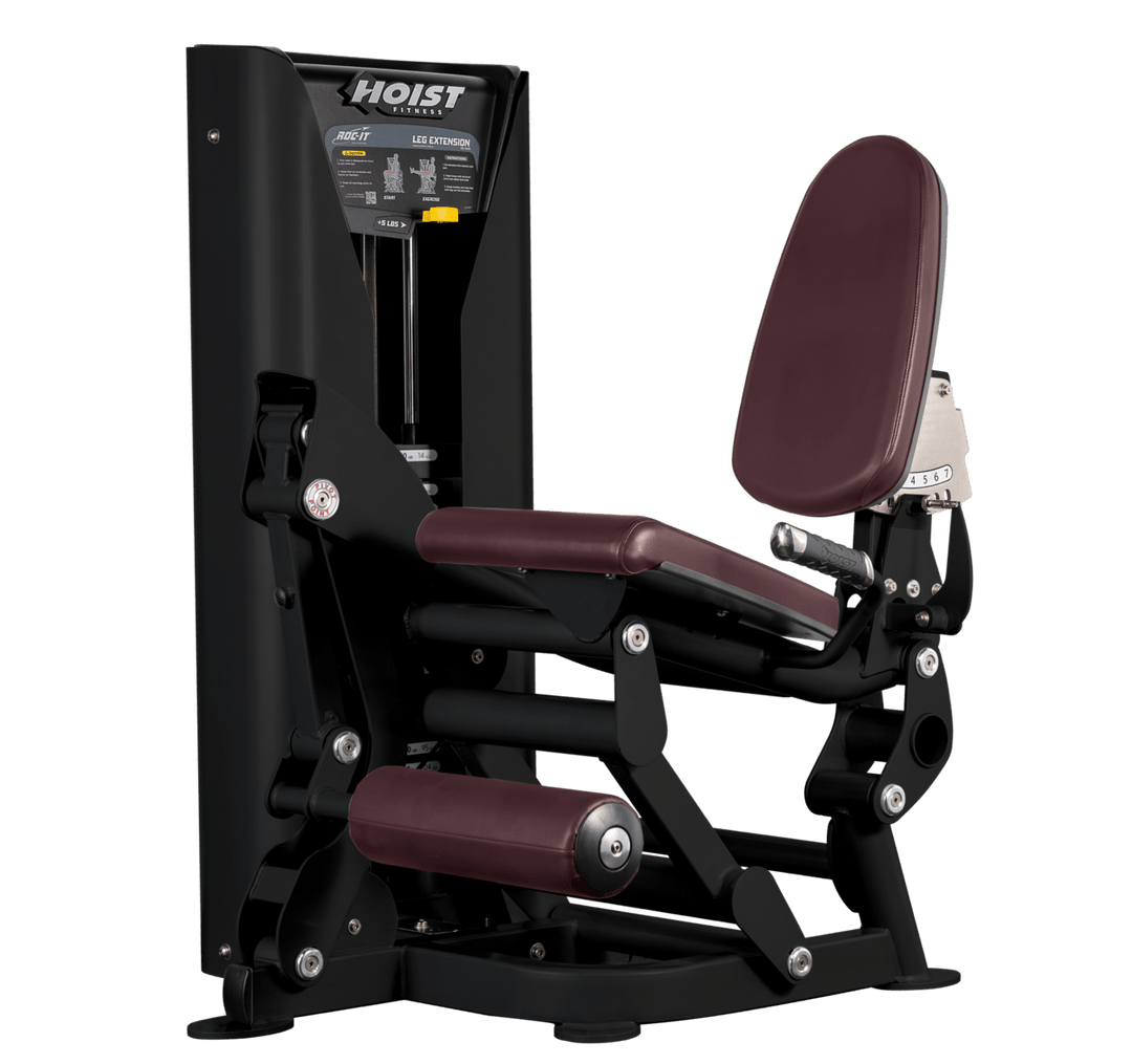Hoist leg extension machine with adjustable seat, padded leg rollers, and weight stack system for quadriceps strengthening exercises