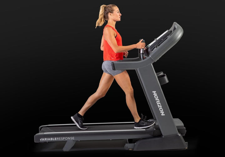 Side profile of a runner using the Horizon Elite 7.0 AT treadmill.
