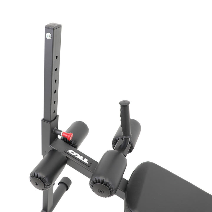 Close-up of the adjustment mechanism and leg rollers on the abdominal bench.