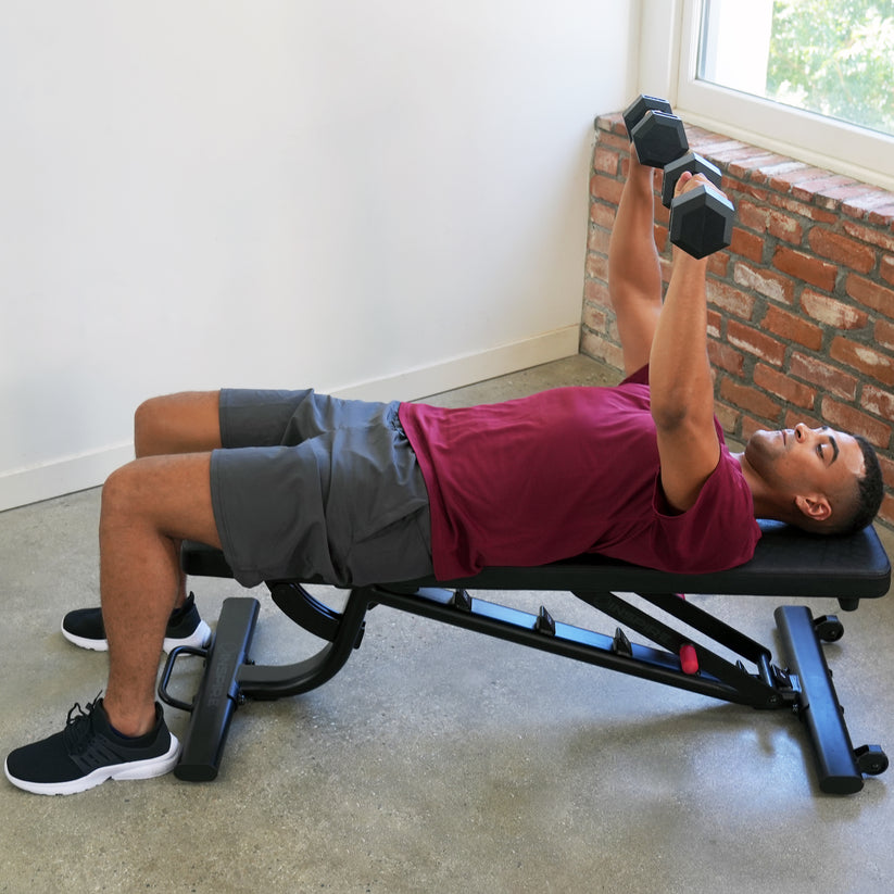 Adjustable weight bench flat setup for dumbbell chest press exercise in home gym strength training routine