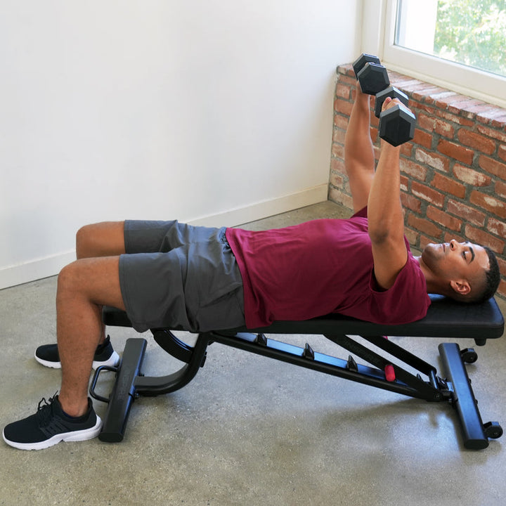 Adjustable weight bench flat setup for dumbbell chest press exercise in home gym strength training routine