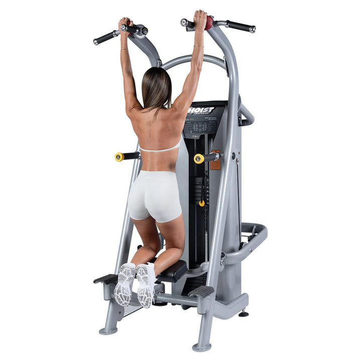person using chin dip assist machine performing assisted pull-up exercise