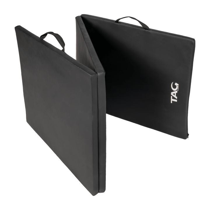 Black tri-fold exercise mat in folded position with stitched carrying handles