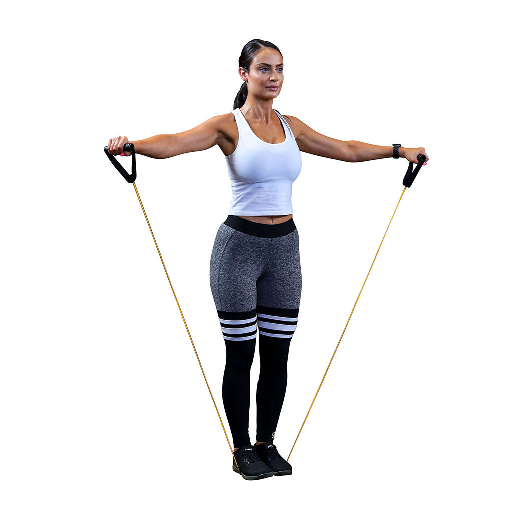 Woman performing a standing shoulder exercise with a Body-Solid resistance tube