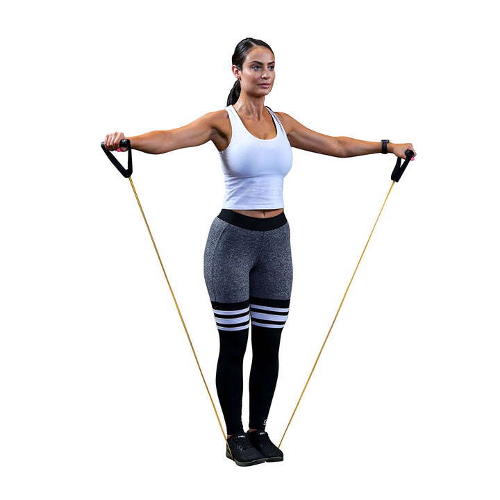 Woman performing a standing shoulder exercise with a Body-Solid resistance tube