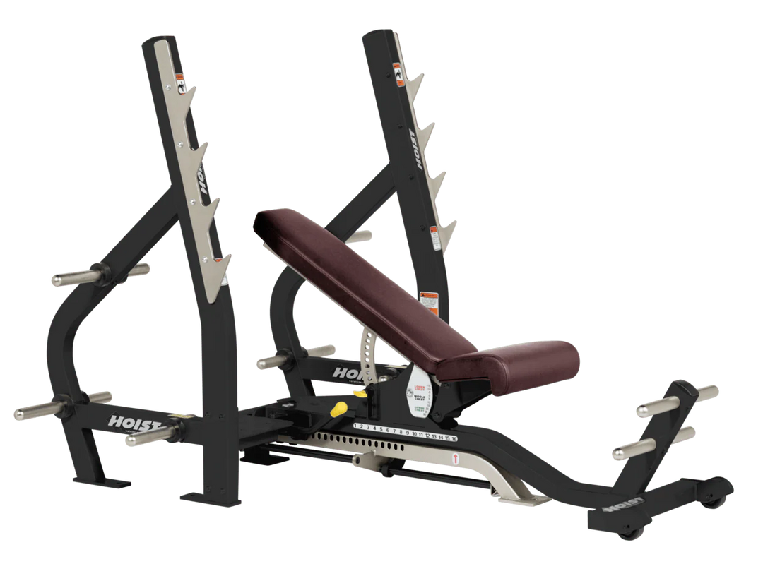 Burgundy HOIST 3-way Olympic bench with adjustable incline decline back pad and barbell rack supports for commercial gym use