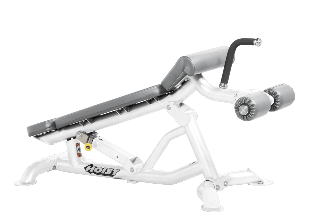 Hoist super flat decline bench with leg hold-down rollers and white dove grey padded seat for strength training exercises
