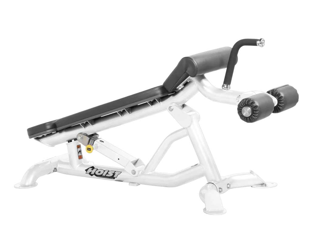 Hoist super flat decline bench with leg hold-down rollers and white slate grey padded seat for strength training exercises