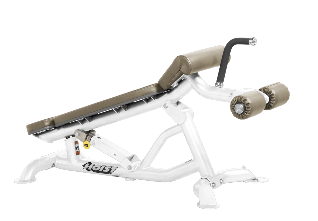 Hoist super flat decline bench with leg hold-down rollers and white suede padded seat for strength training exercises