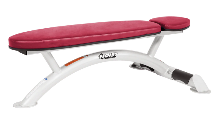 Hoist commercial flat bench with white american beauty padding and curved steel frame for weightlifting and strength training