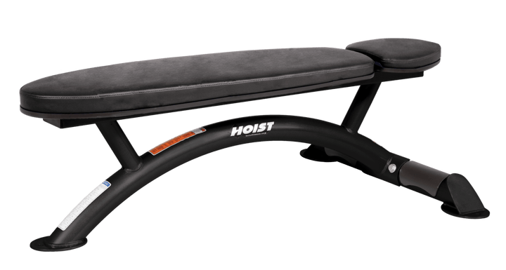 Hoist commercial flat bench with black padding and curved steel frame for weightlifting and strength training