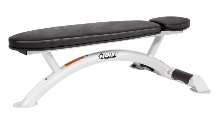 Hoist commercial flat bench with white black padding and curved steel frame for weightlifting and strength training