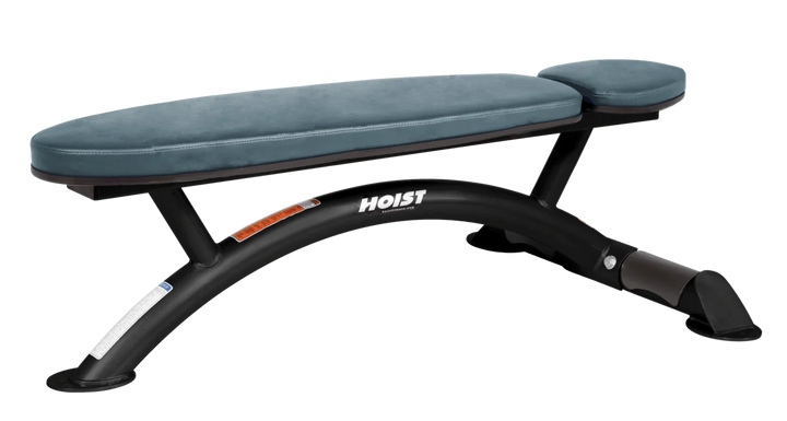 Hoist commercial flat bench with blue ridge padding and curved steel frame for weightlifting and strength training