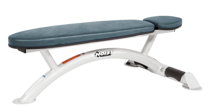 Hoist commercial flat bench with white blue ridge padding and curved steel frame for weightlifting and strength training
