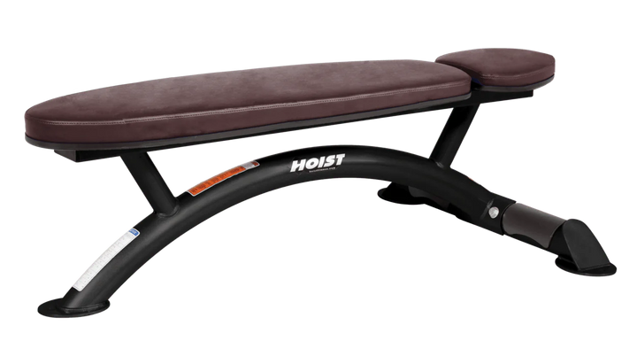 Hoist commercial flat bench with burgundy padding and curved steel frame for weightlifting and strength training