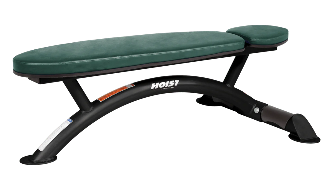 Hoist commercial flat bench with hunter green padding and curved steel frame for weightlifting and strength training