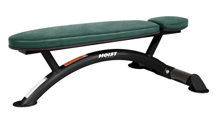 Hoist commercial flat bench with hunter green padding and curved steel frame for weightlifting and strength training