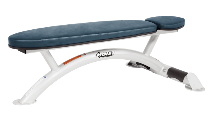 Hoist commercial flat bench with white navy blue padding and curved steel frame for weightlifting and strength training
