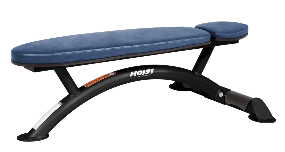 Hoist commercial flat bench with royal blue padding and curved steel frame for weightlifting and strength training