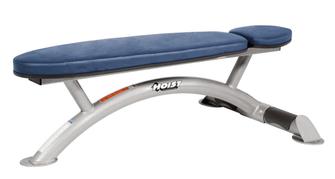 Hoist commercial flat bench with platinum royal blue padding and curved steel frame for weightlifting and strength training