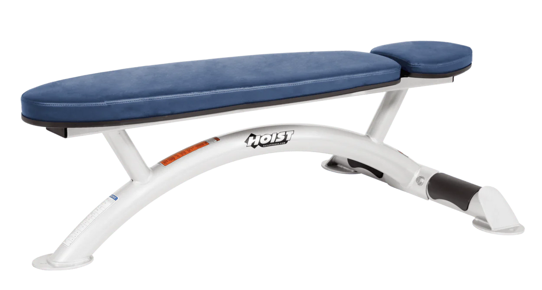 Hoist commercial flat bench with white royal blue padding and curved steel frame for weightlifting and strength training