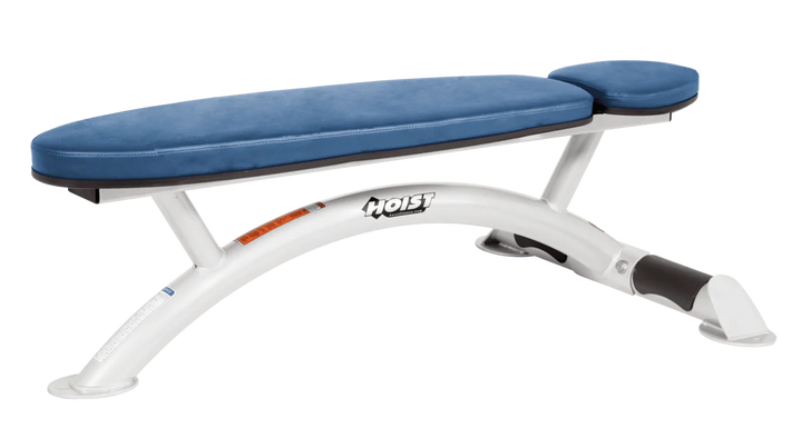 Hoist commercial flat bench with white sky blue padding and curved steel frame for weightlifting and strength training