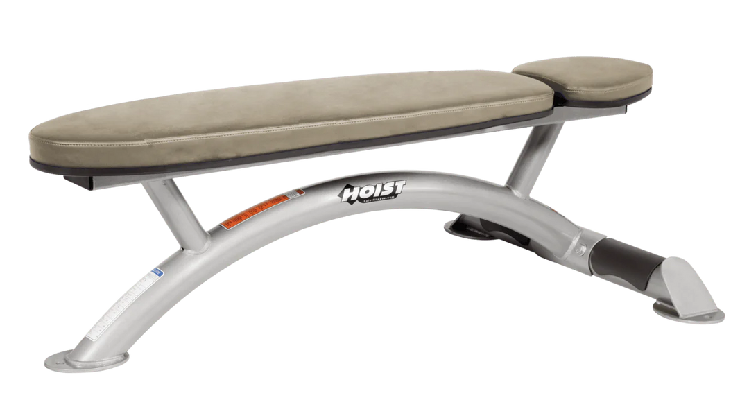Hoist commercial flat bench with platinum suede padding and curved steel frame for weightlifting and strength training