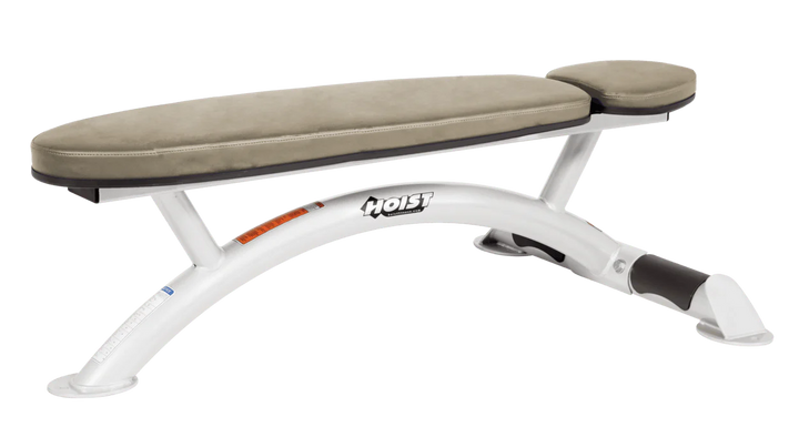 Hoist commercial flat bench with white suede padding and curved steel frame for weightlifting and strength training