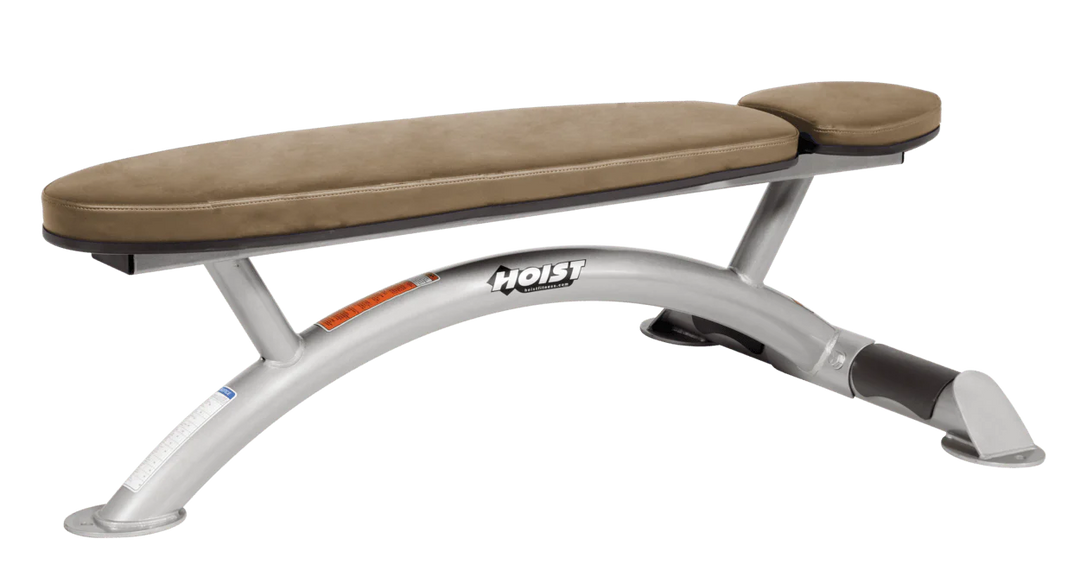 Hoist commercial flat bench with platinum wheat padding and curved steel frame for weightlifting and strength training