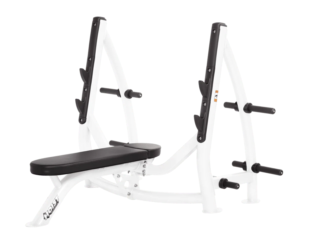 Hoist white black commercial Olympic flat bench with built-in weight plate storage and barbell rack for strength training