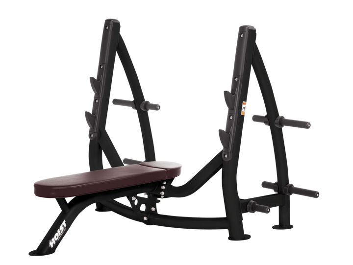 Hoist burgundy commercial Olympic flat bench with built-in weight plate storage and barbell rack for strength training