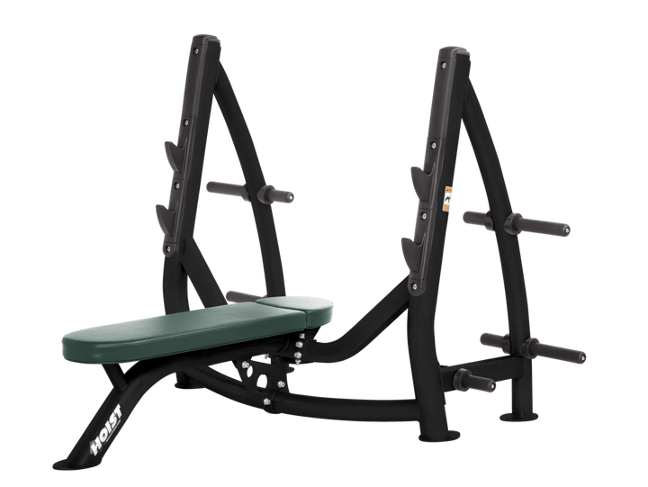 Hoist hunter green commercial Olympic flat bench with built-in weight plate storage and barbell rack for strength training