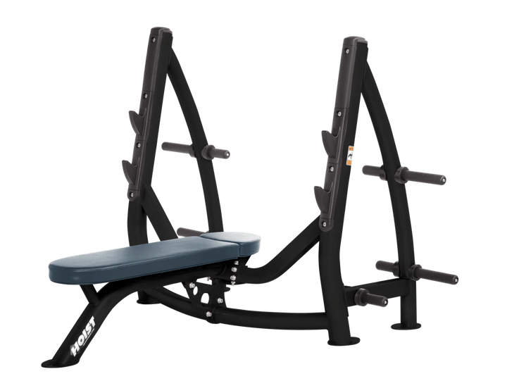 Hoist navy blue commercial Olympic flat bench with built-in weight plate storage and barbell rack for strength training