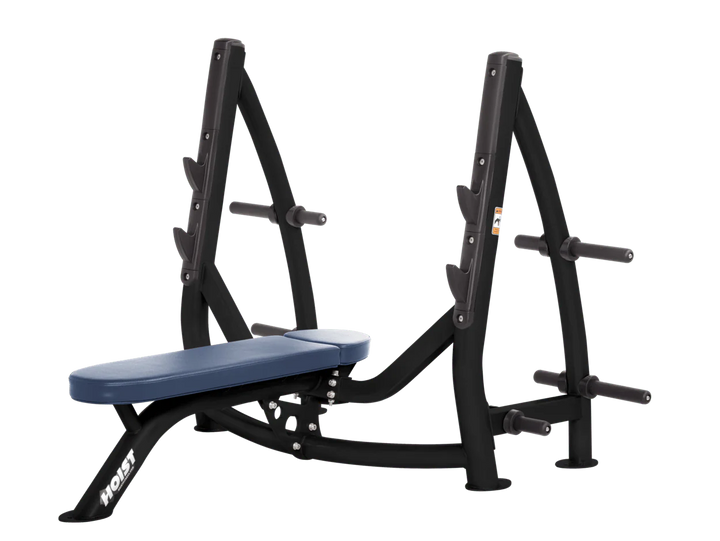 Hoist royal blue commercial Olympic flat bench with built-in weight plate storage and barbell rack for strength training