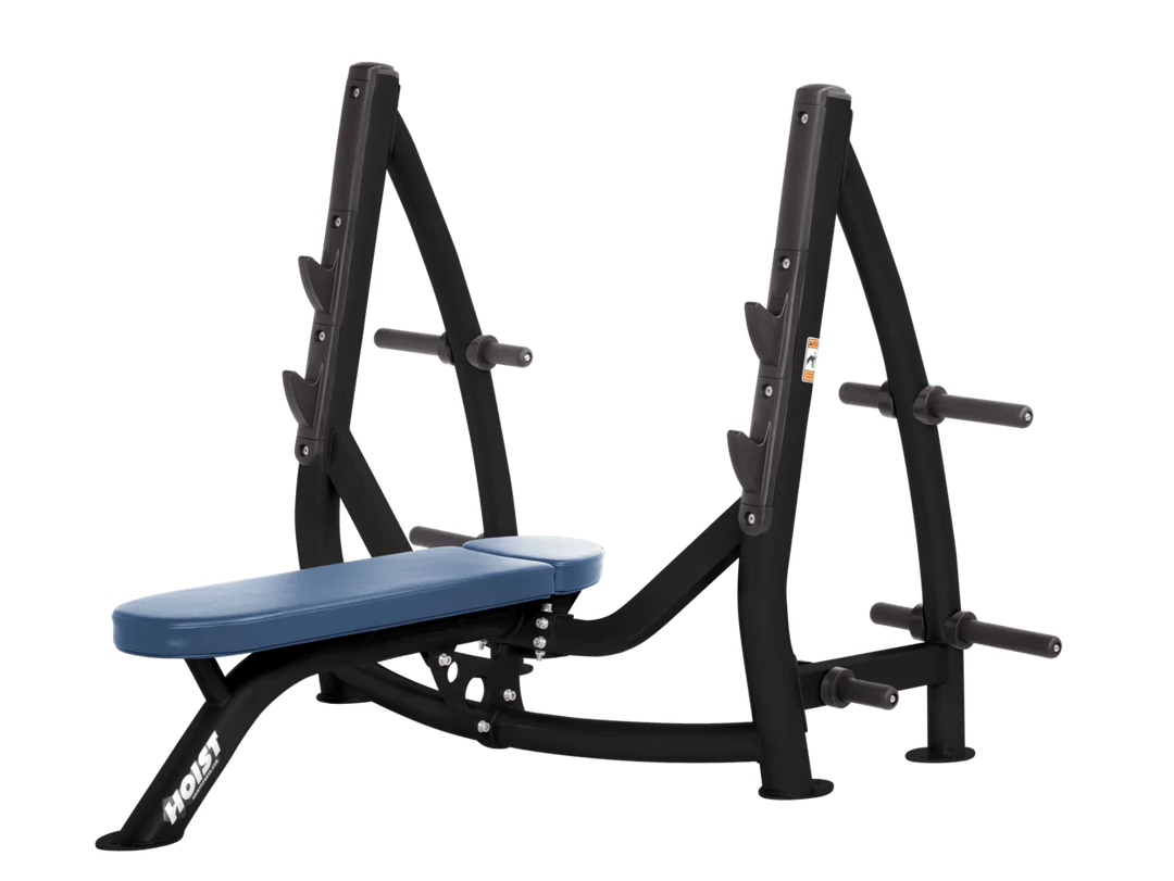 Hoist sky blue commercial Olympic flat bench with built-in weight plate storage and barbell rack for strength training