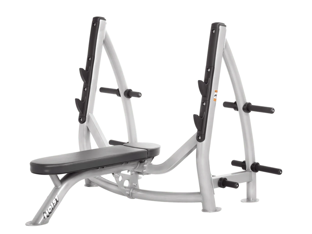 Hoist platinum slate grey commercial Olympic flat bench with built-in weight plate storage and barbell rack for strength training