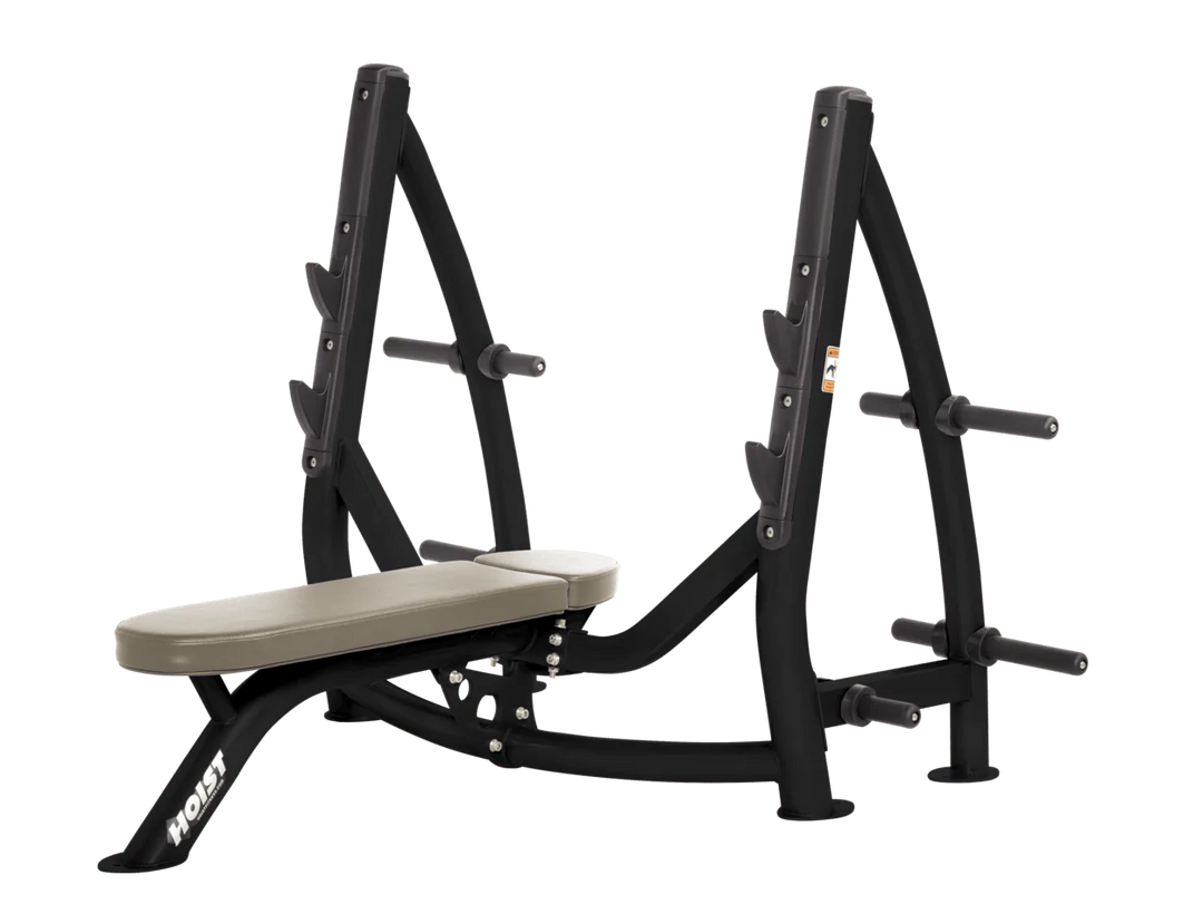 Hoist Suede commercial Olympic flat bench with built-in weight plate storage and barbell rack for strength training