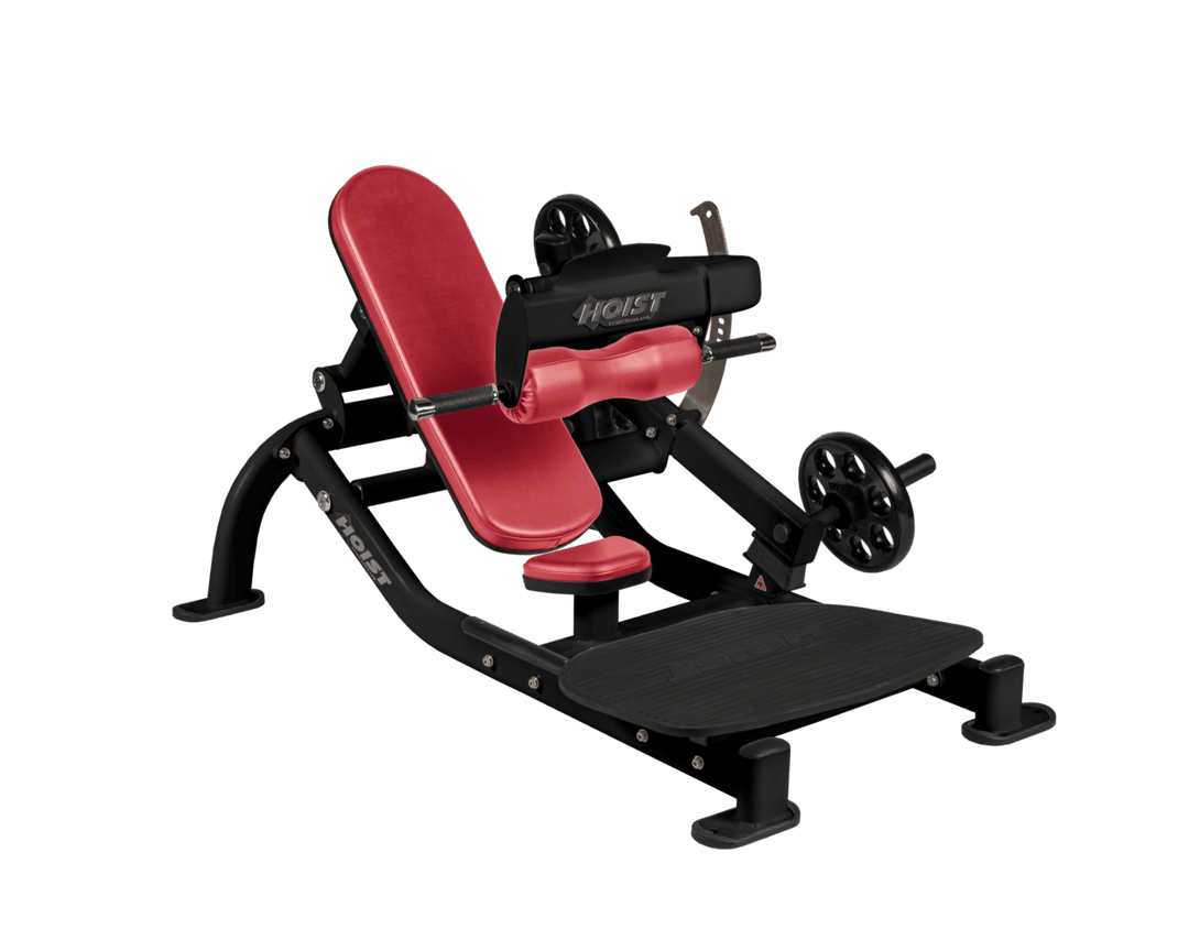 Angled view of AMB Matte Black glute thrust machine showing foot platform, seat, and weight plate loading positions