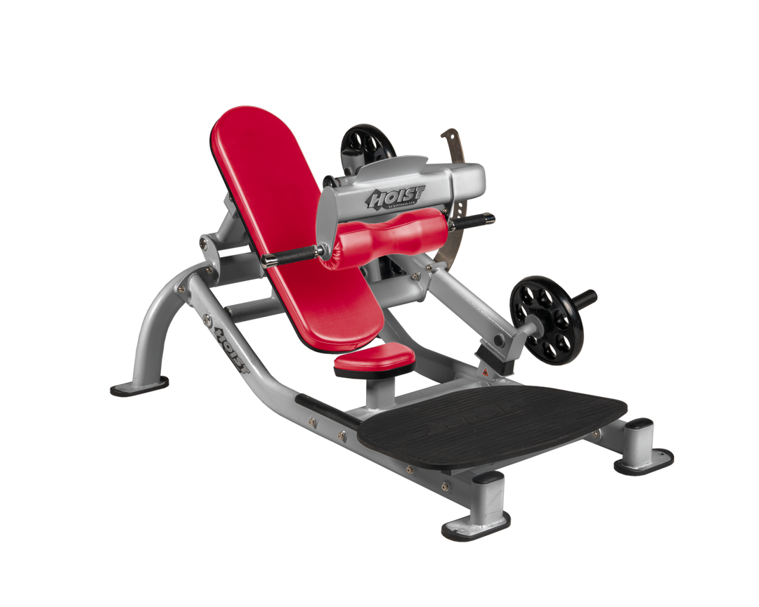 Angled view of AMB Platinum glute thrust machine showing foot platform, seat, and weight plate loading positions
