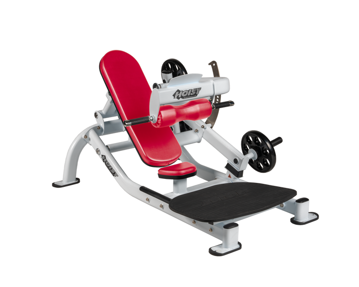 Angled view of AMB White glute thrust machine showing foot platform, seat, and weight plate loading positions
