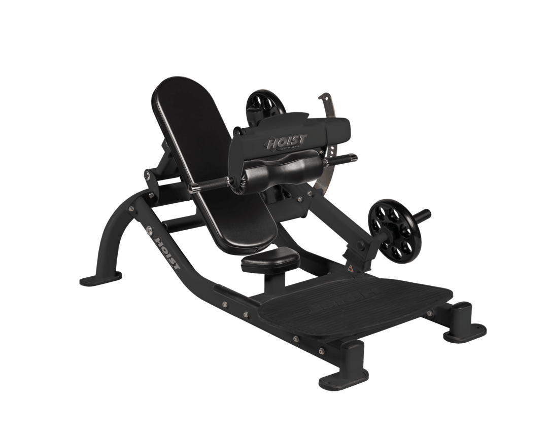 Angled view of Matte Black glute thrust machine showing foot platform, seat, and weight plate loading positions