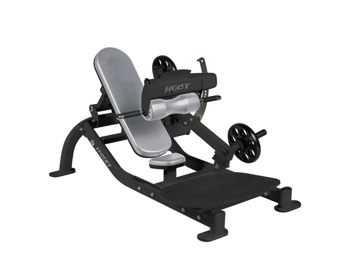 Angled view of DVG Matte Black glute thrust machine showing foot platform, seat, and weight plate loading positions
