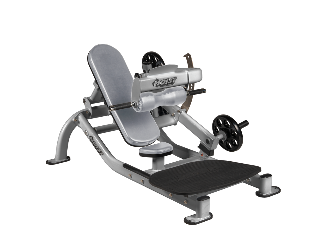 Angled view of DVG Platinum glute thrust machine showing foot platform, seat, and weight plate loading positions