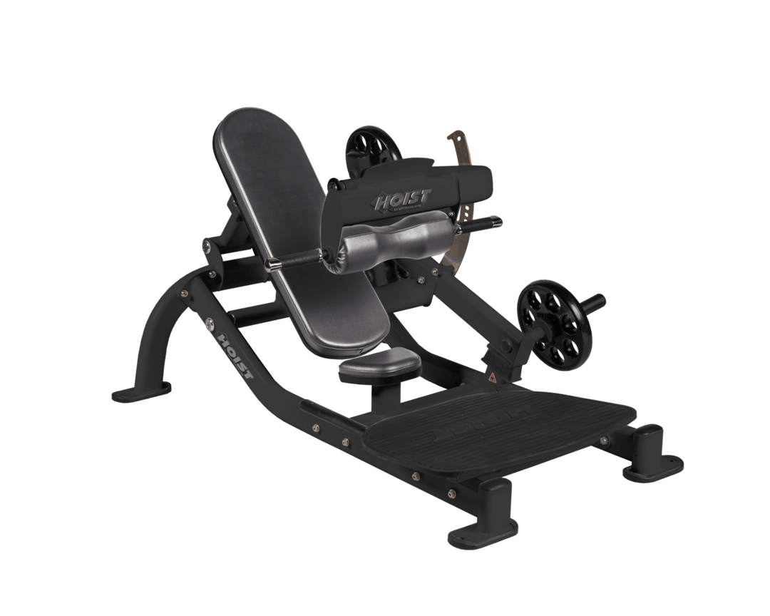 Angled view of SLG Matte Black glute thrust machine showing foot platform, seat, and weight plate loading positions