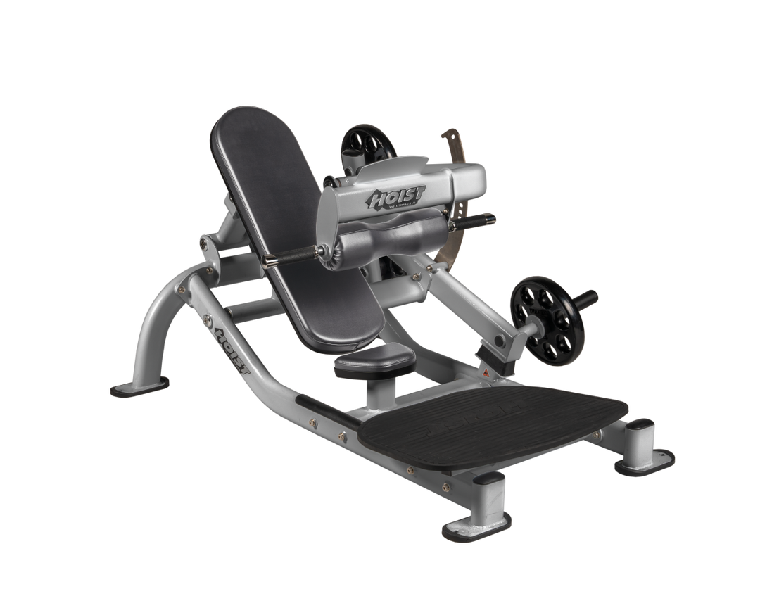 Angled view of SLG Platinum glute thrust machine showing foot platform, seat, and weight plate loading positions