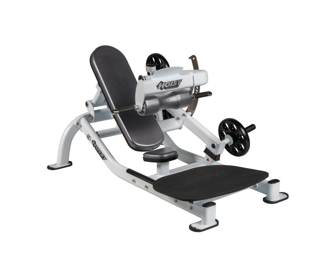 Angled view of SLG White glute thrust machine showing foot platform, seat, and weight plate loading positions