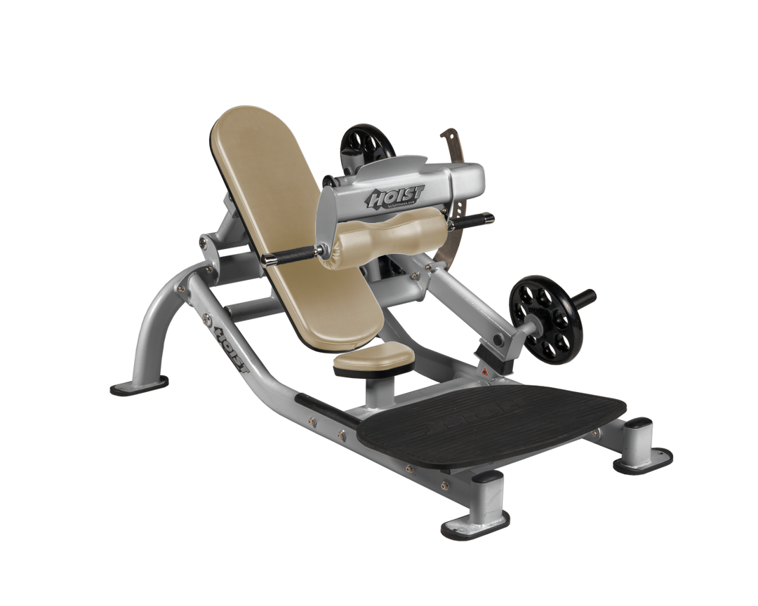 Angled view of SUE Platinum glute thrust machine showing foot platform, seat, and weight plate loading positions