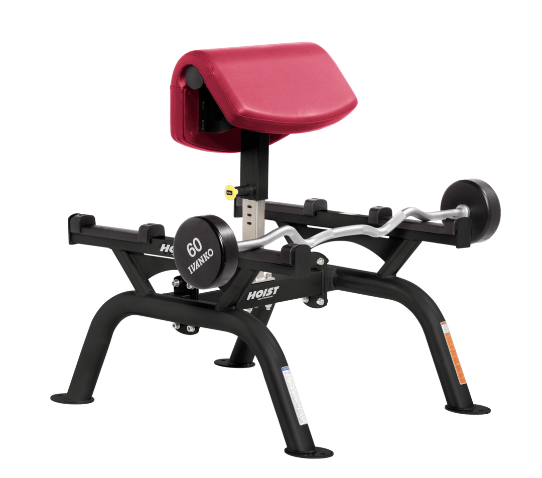 AMB Commercial standing preacher curl machine with angled arm pad and plate-loaded bar for focused bicep training