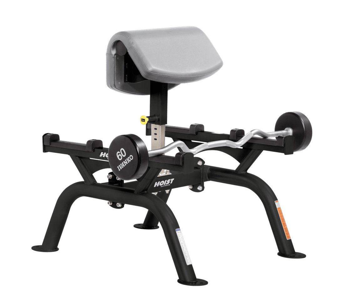 DVG Commercial standing preacher curl machine with angled arm pad and plate-loaded bar for focused bicep training