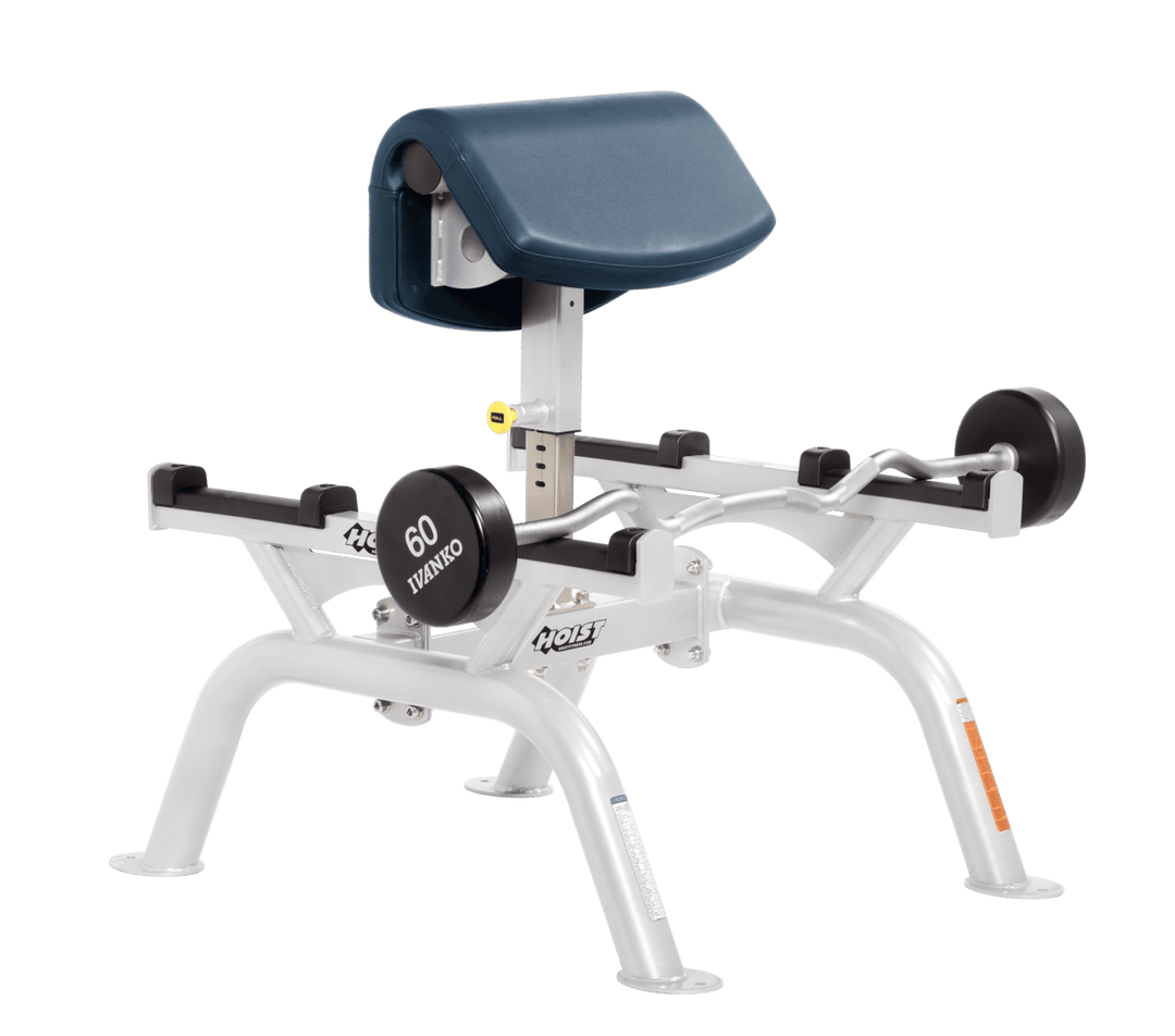 NVY Commercial standing preacher curl machine with white angled arm pad and plate-loaded bar for focused bicep training